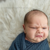 Newborn Grumpy Baby Breaks The Internet With Squishy Cheeks, Zero Smiles, And All Sass