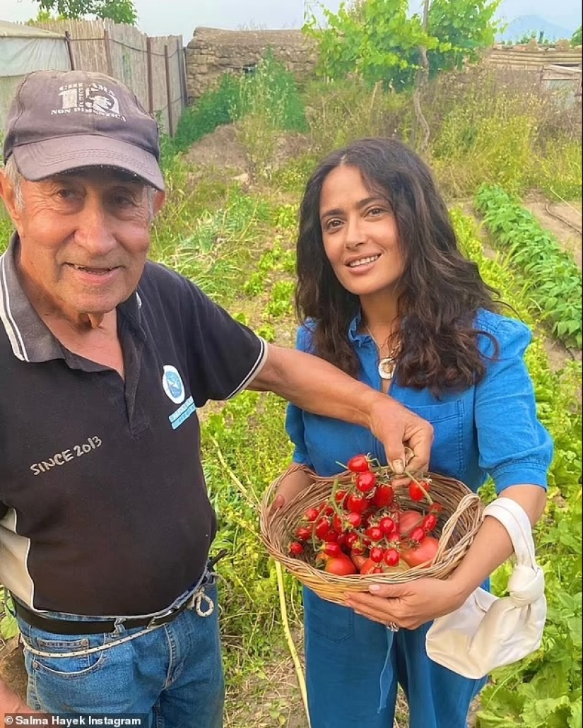 Salma Hayek, 57, is a makeup-free beauty as she eats a strawberry fresh off the vine during trip to 'magical' island in Italy