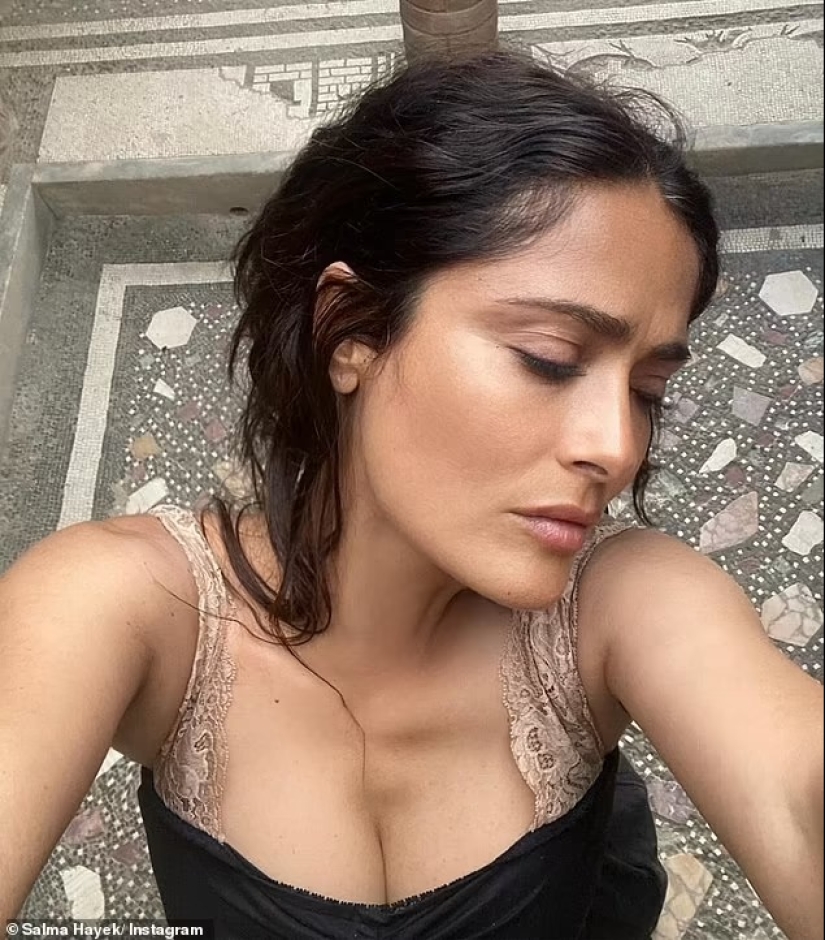 Salma Hayek, 57, is a makeup-free beauty as she eats a strawberry fresh off the vine during trip to 'magical' island in Italy