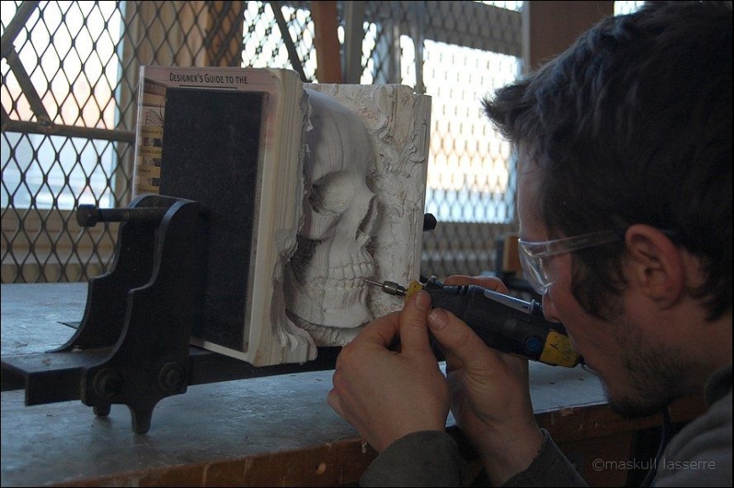 Step-by-step process of carving a skull from old books