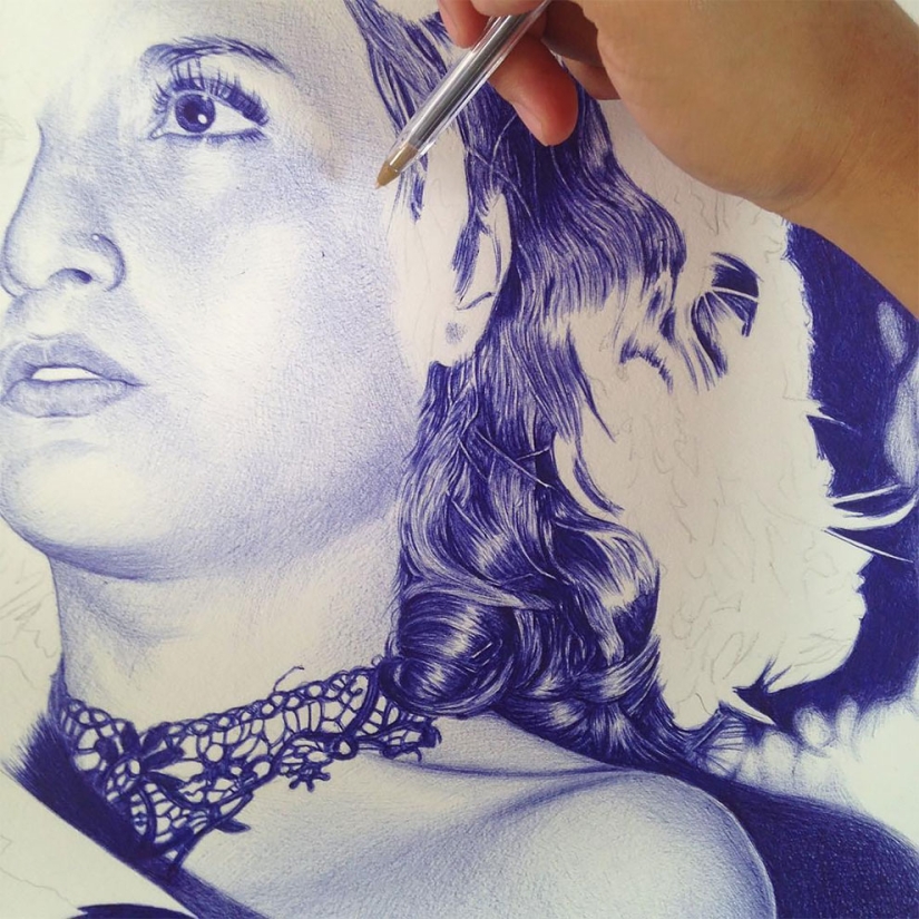 The superiority of blue: a young man writes fascinating pictures with a ballpoint pen