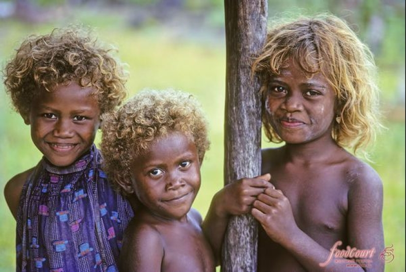 Where did dark-skinned people with light hair come from in Melanesia