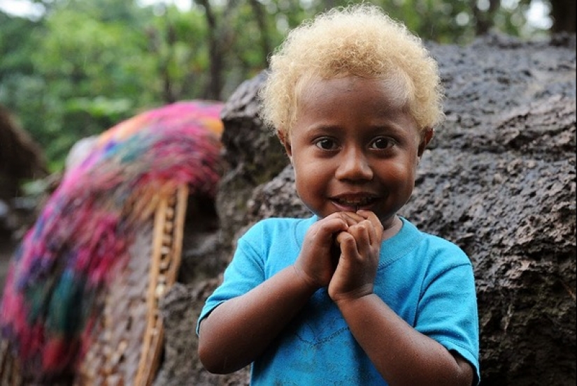 Where did dark-skinned people with light hair come from in Melanesia