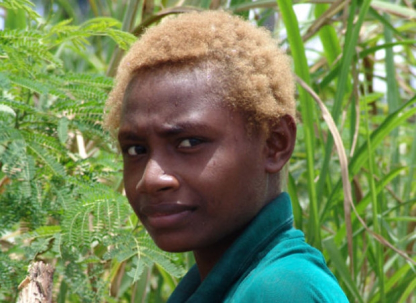 Where did dark-skinned people with light hair come from in Melanesia