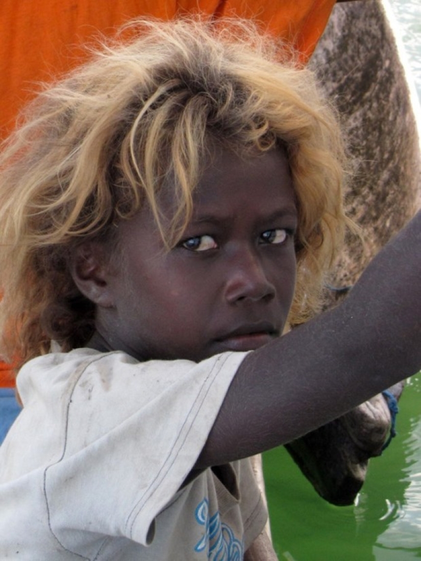 Where did dark-skinned people with light hair come from in Melanesia