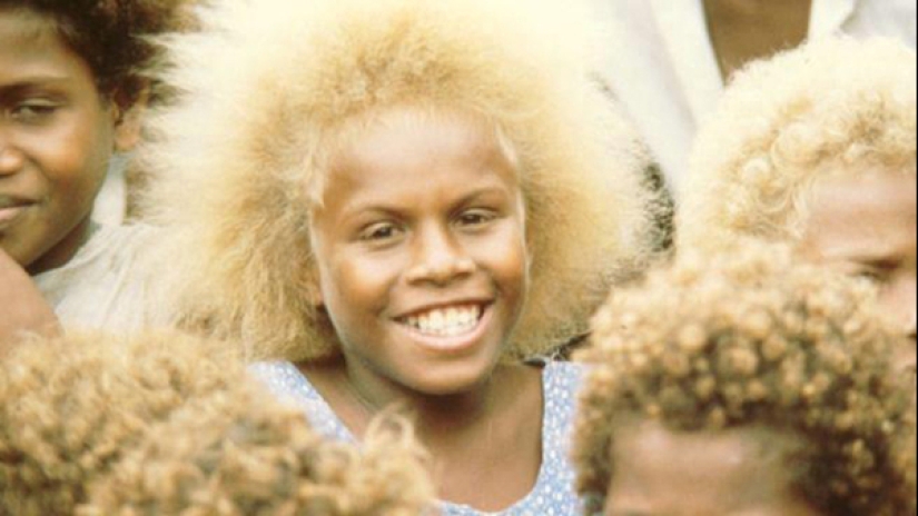 Where did dark-skinned people with light hair come from in Melanesia