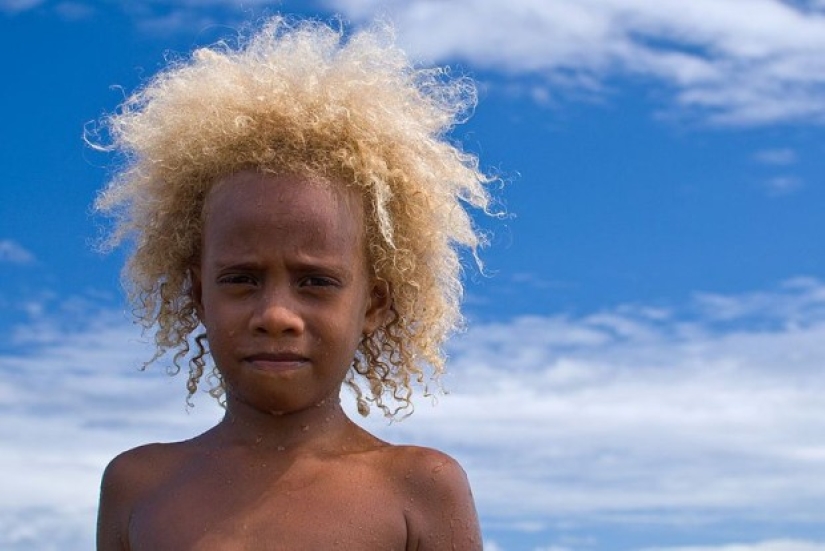 Where did dark-skinned people with light hair come from in Melanesia