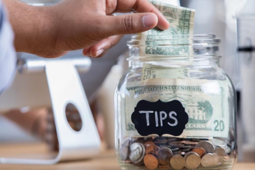 Where did the tradition of leaving tips come from and why do we misunderstand it