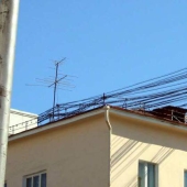 Who and why stretches wires between houses