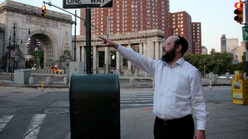 Why do Jews stretch kilometers of fishing line over cities around the world?