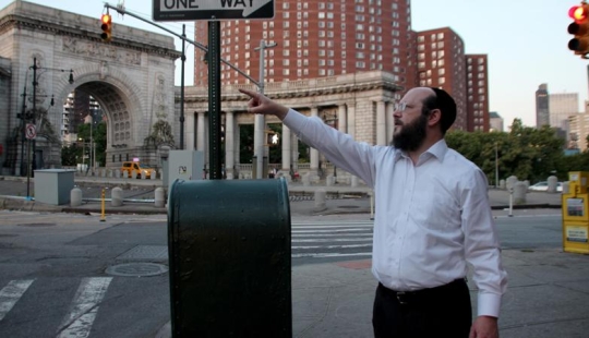 Why do Jews stretch kilometers of fishing line over cities around the world?