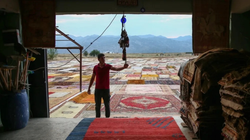Why do the Turks lay out thousands of carpets in the fields?