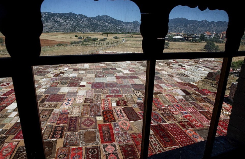 Why do the Turks lay out thousands of carpets in the fields?