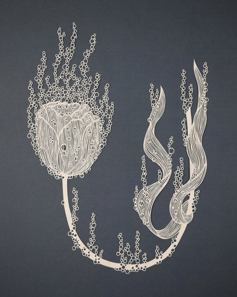 A girl cuts out intricate masterpieces from paper A girl cuts out intricate masterpieces from paper