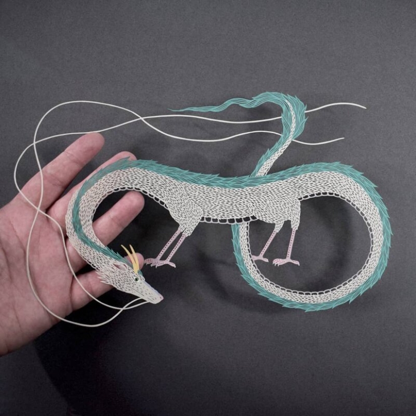 A girl cuts out intricate masterpieces from paper A girl cuts out intricate masterpieces from paper