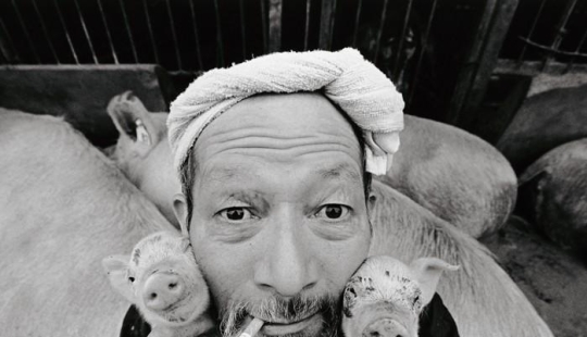 Happy pig farmer and his pets