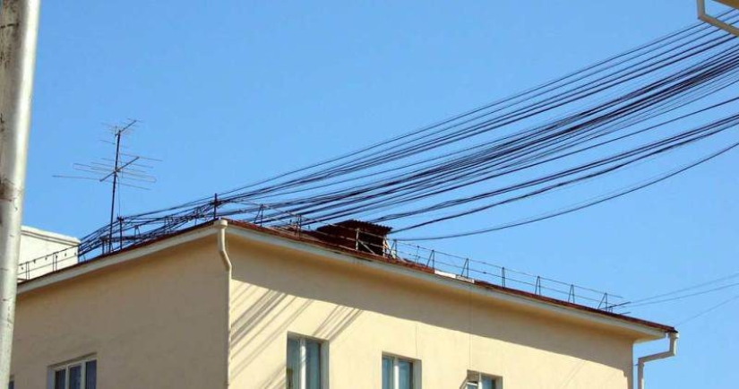 Who and why stretches wires between houses Who and why stretches wires between houses