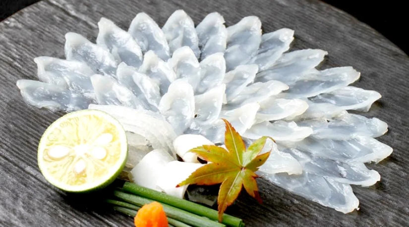 Why do gourmets value the deadly puffer fish and what risks do they take?